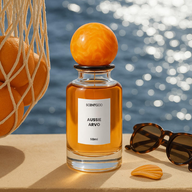 Aussie Avro Bottle sitting on a ledge in the sun with sunglasses and oranges.